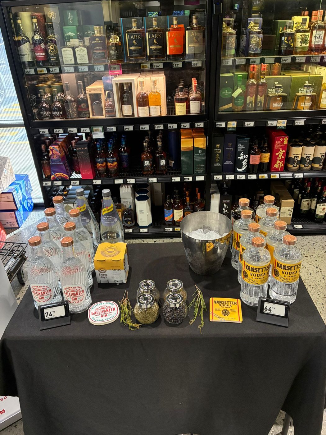 Gallivanter Gin and Vansetter Vodka tasting table with botanicals and price tickets